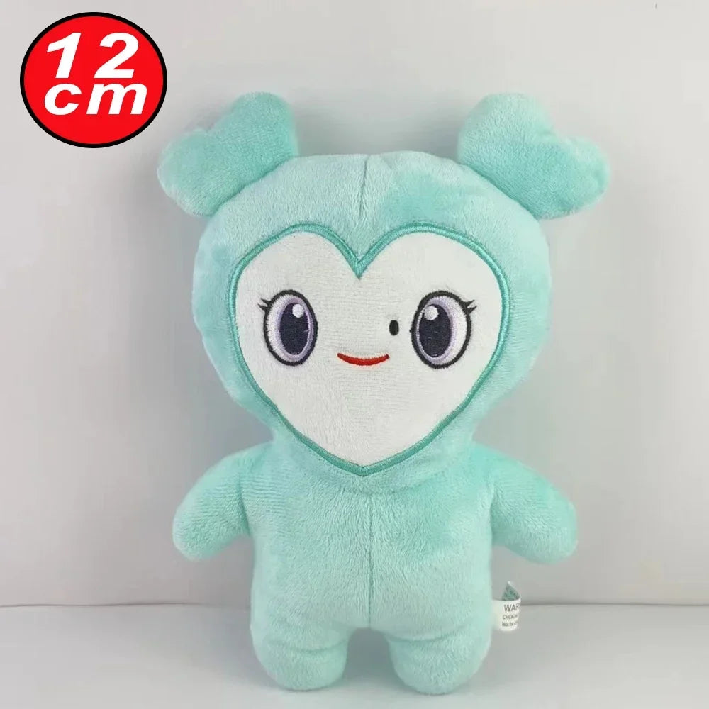 A soft mint green plush toy shaped like a cute animal face with large eyes and pink accents.
