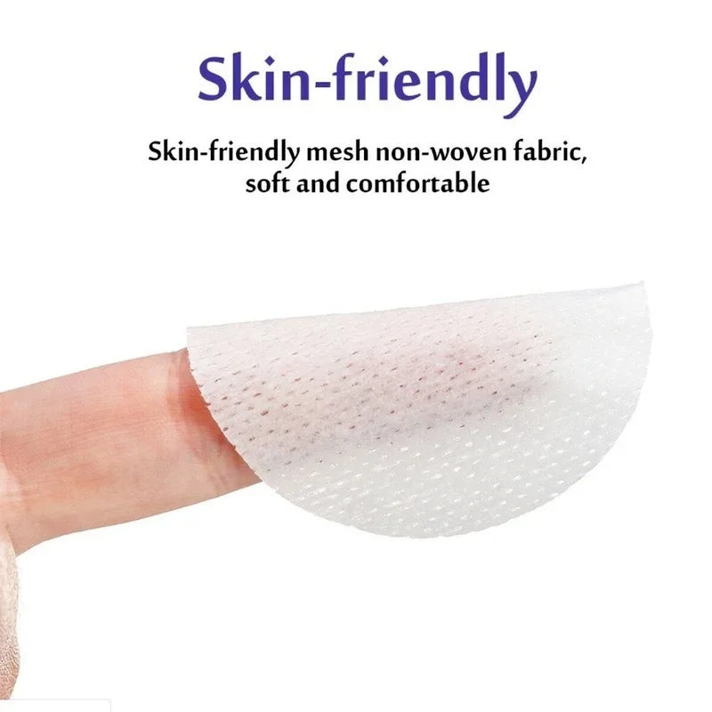 A hand is holding a white, mesh non-woven fabric wipe for pet eye and ear cleaning.