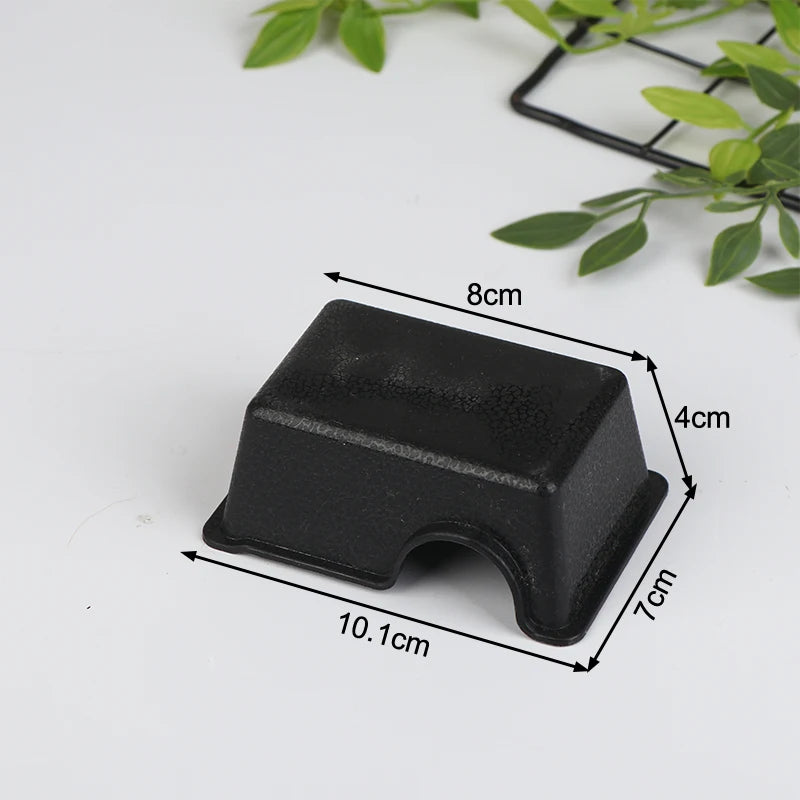 A black reptile hide box enclosure with dimensions 8cm by 4cm and a depth of 7cm.