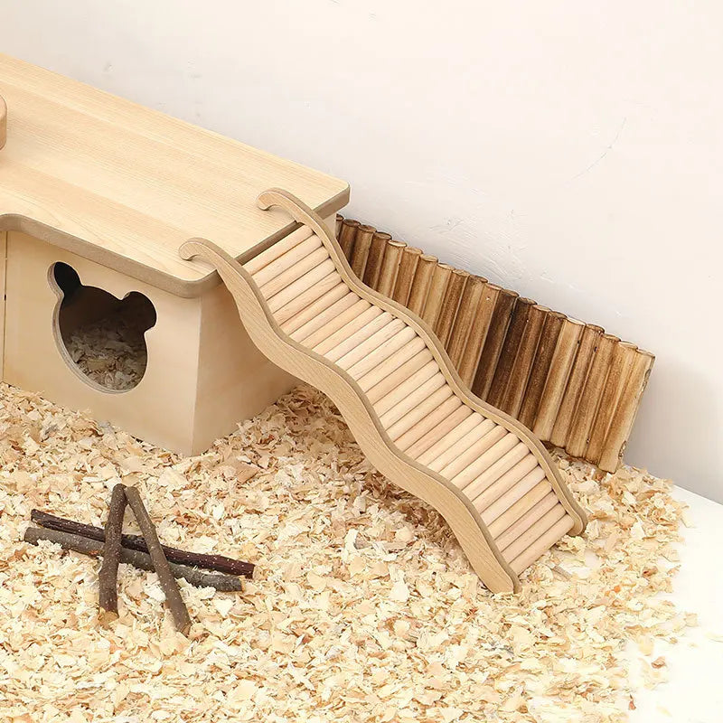 A wooden wave staircase and curved slide for a hamster toy placed on a light surface.