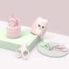 A pink kids portable nail care set featuring a storage container and small pink nail clippers.