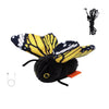 A black and yellow butterfly toy with a fuzzy body and attached string for a cat teaser.