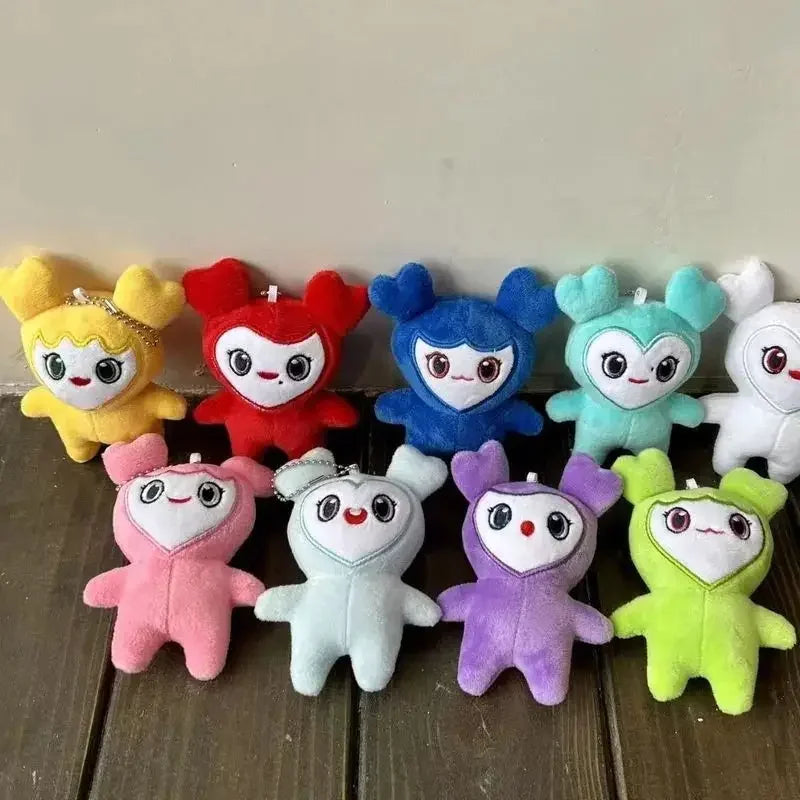 A collection of twelve colorful kawaii Momo plush keychains arranged in a row.