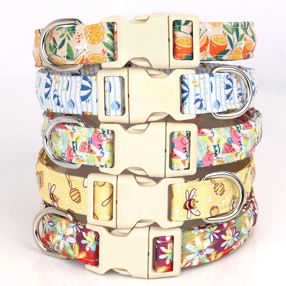 A stack of adjustable nylon dog collars featuring various bee and flower print patterns.