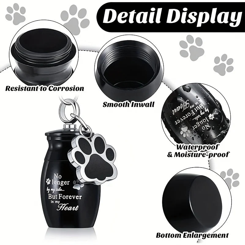 Detail display of a black stainless steel memorial pet ashes keychain with a paw print design.