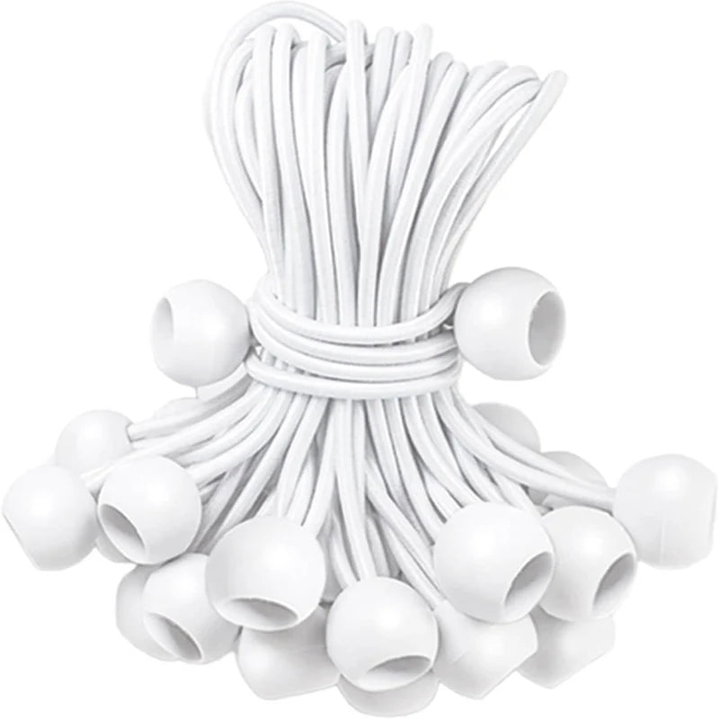 A bundle of white bungee balls with cords used for securing tarps, tents, and camping gear.