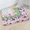 A colorful washable pet training mat for dogs featuring various patterns and rainbow designs.