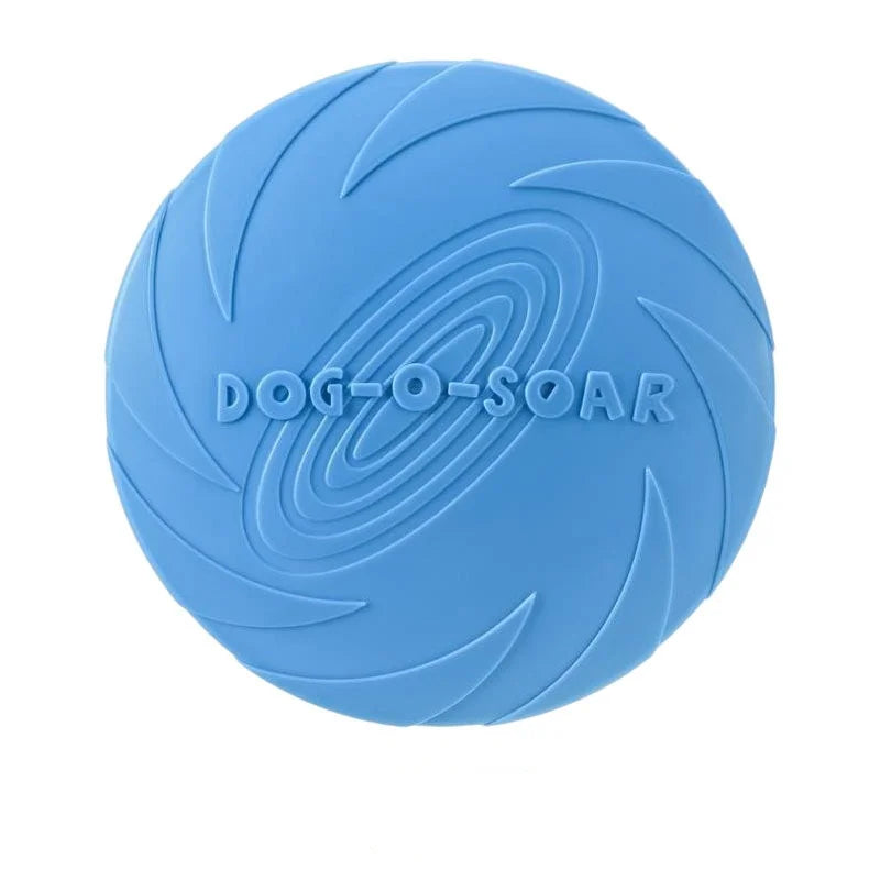 A bright blue silicone flying disc for dogs with the text DOG-O-SOAR molded into its surface.