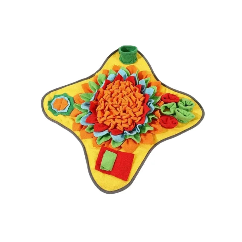 A colorful, felt mat shaped like a flower with various fabric petals and a green handle for an interactive sniffing tool.