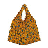 A vibrant yellow floral fabric tote bag with blue accents.