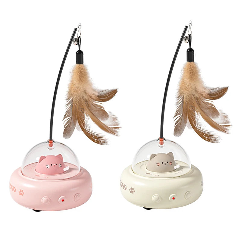 A pink interactive UFO cat teaser wand with feathers and a bell is shown against a white background.