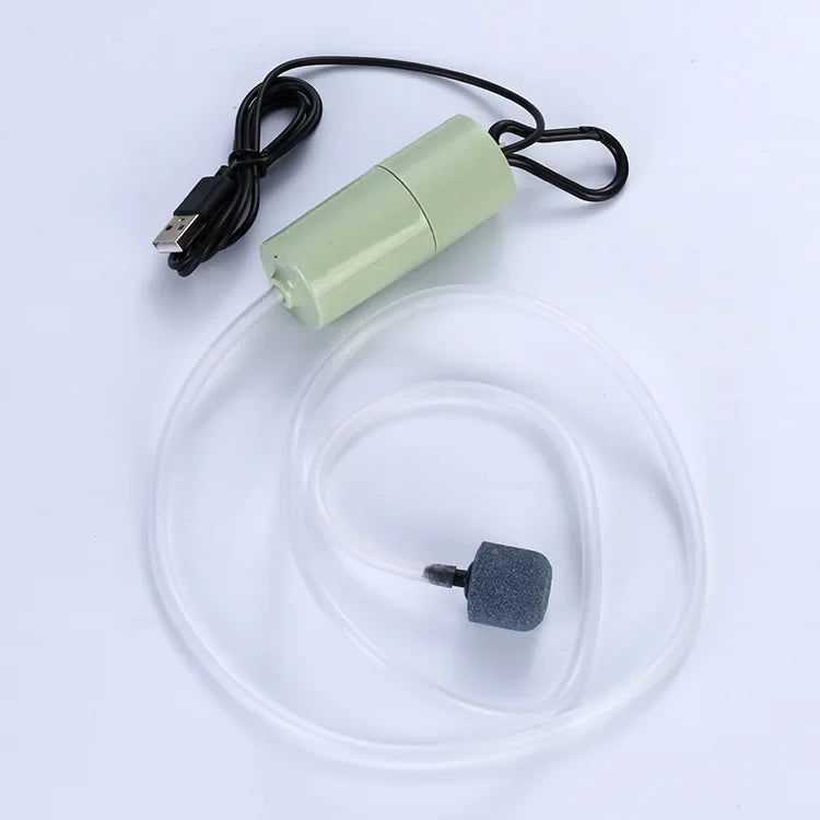 A USB silent air pump with a green housing and clear tubing is shown for aquarium oxygenation.