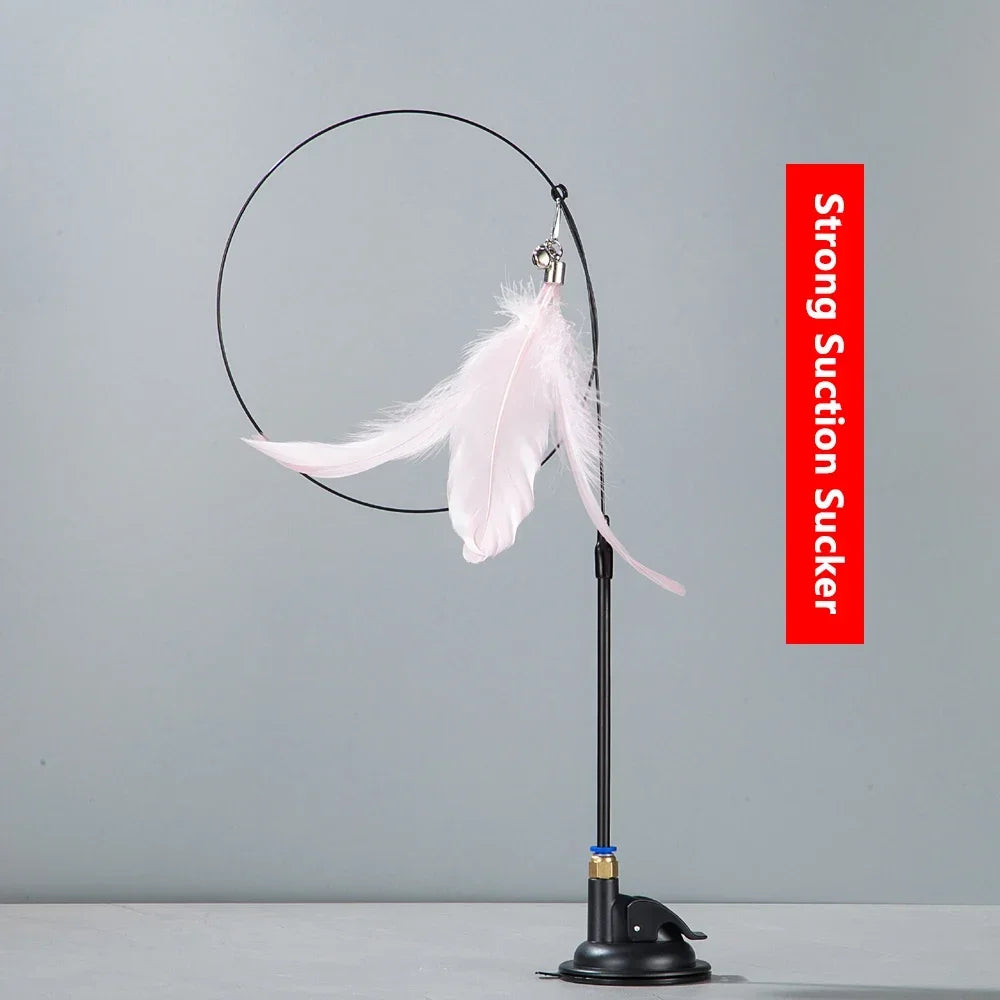 A black suction cup hanging with a white feather on a stand.