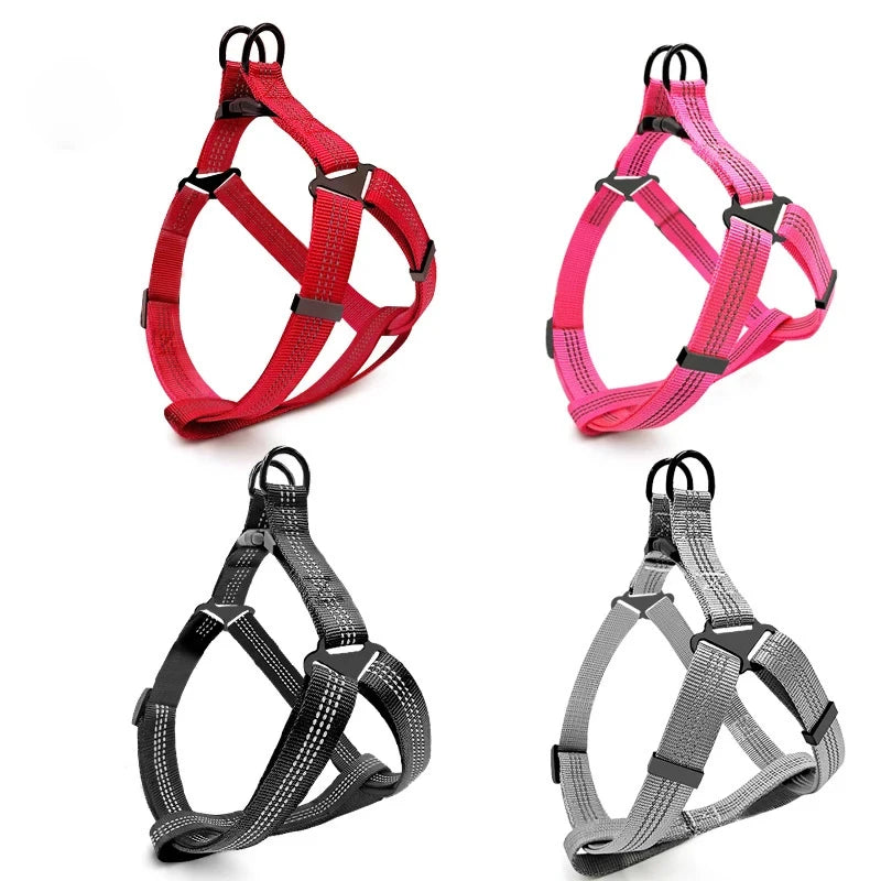 Three brightly colored dog harnesses in red, pink, and gray for dogs.
