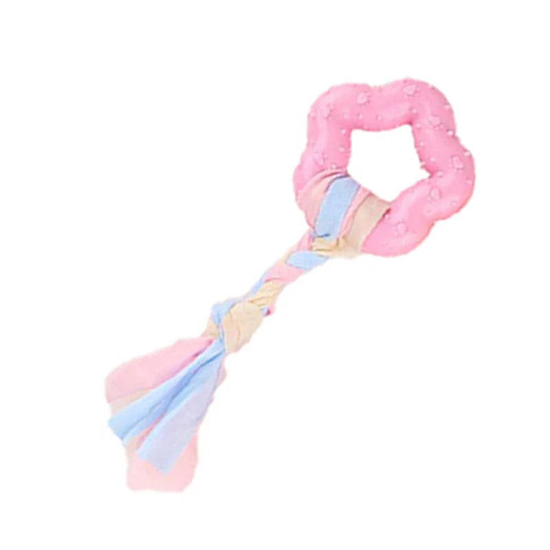 Pink rubber chew toy for small dogs with a dental cleaning texture, tied with blue and pink fabric.