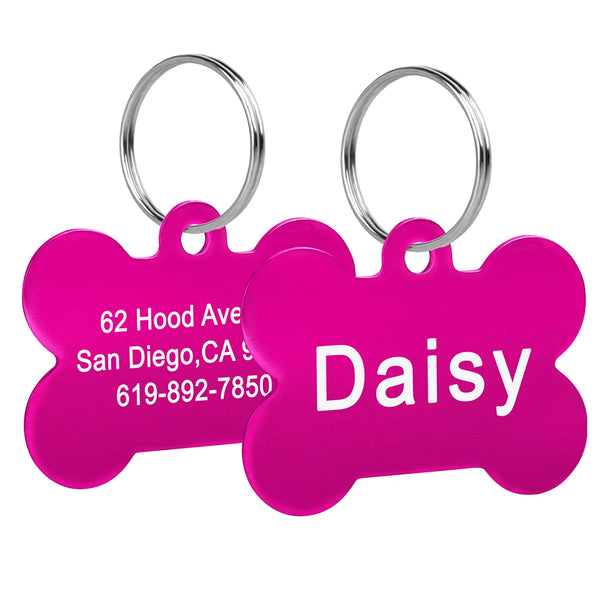 A bright pink stainless steel bone pet ID tag with the name Daisy and contact information engraved on it.