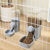 A pet feeder with two compartments is shown inside a wire cage, featuring dry food for dogs and cats.