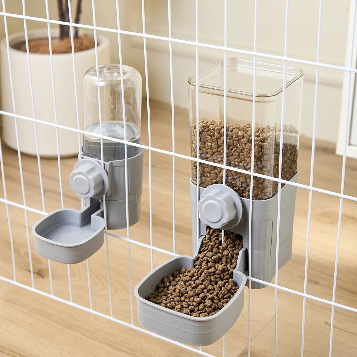 A pet feeder with two compartments is shown inside a wire cage, featuring dry food for dogs and cats.