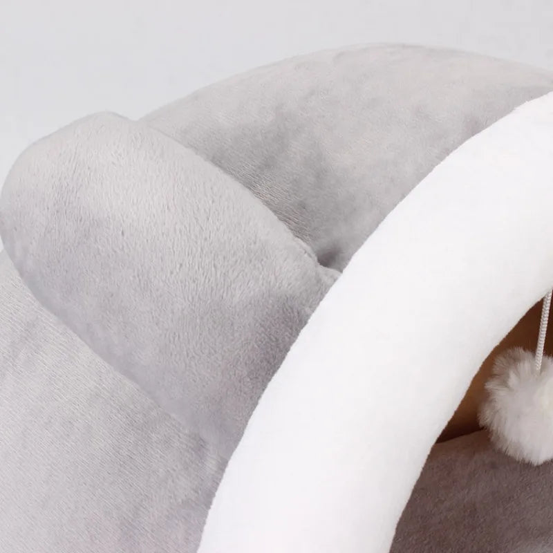 A close-up of a cozy foldable pet cave bed in gray and white faux fur texture.