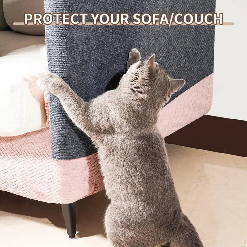 A gray cat is interacting with a sofa protector pad designed to prevent scratching.