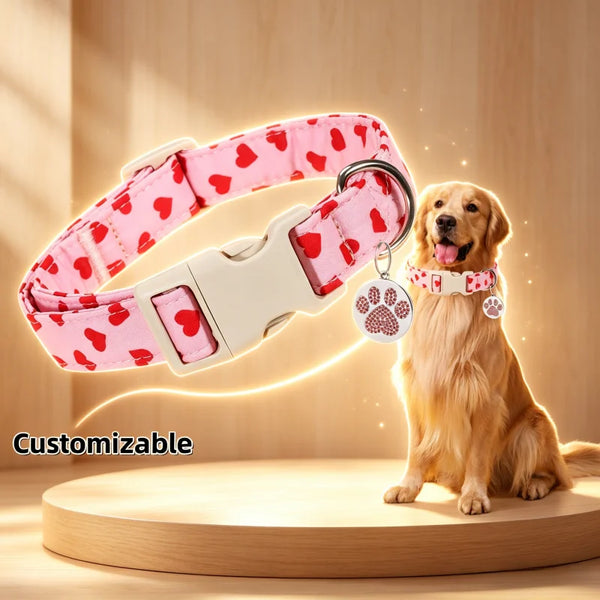 A customizable pink heart patterned nylon dog collar with a paw print charm is shown next to a golden retriever.