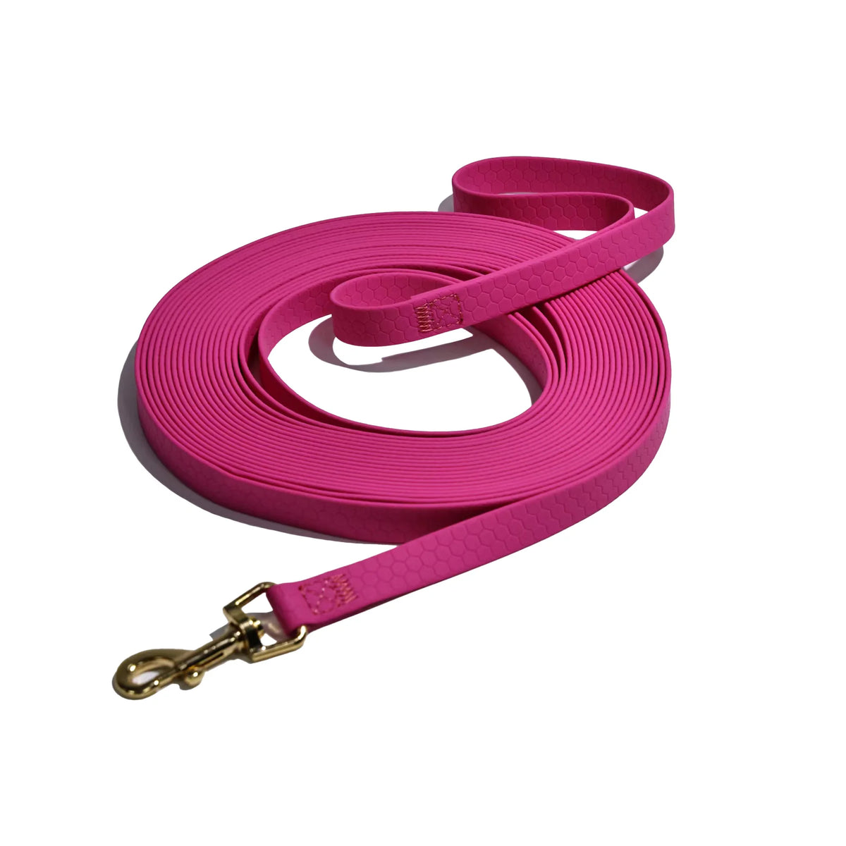 A bright pink durable waterproof dog leash with a rustproof metal hook coiled on a white background.