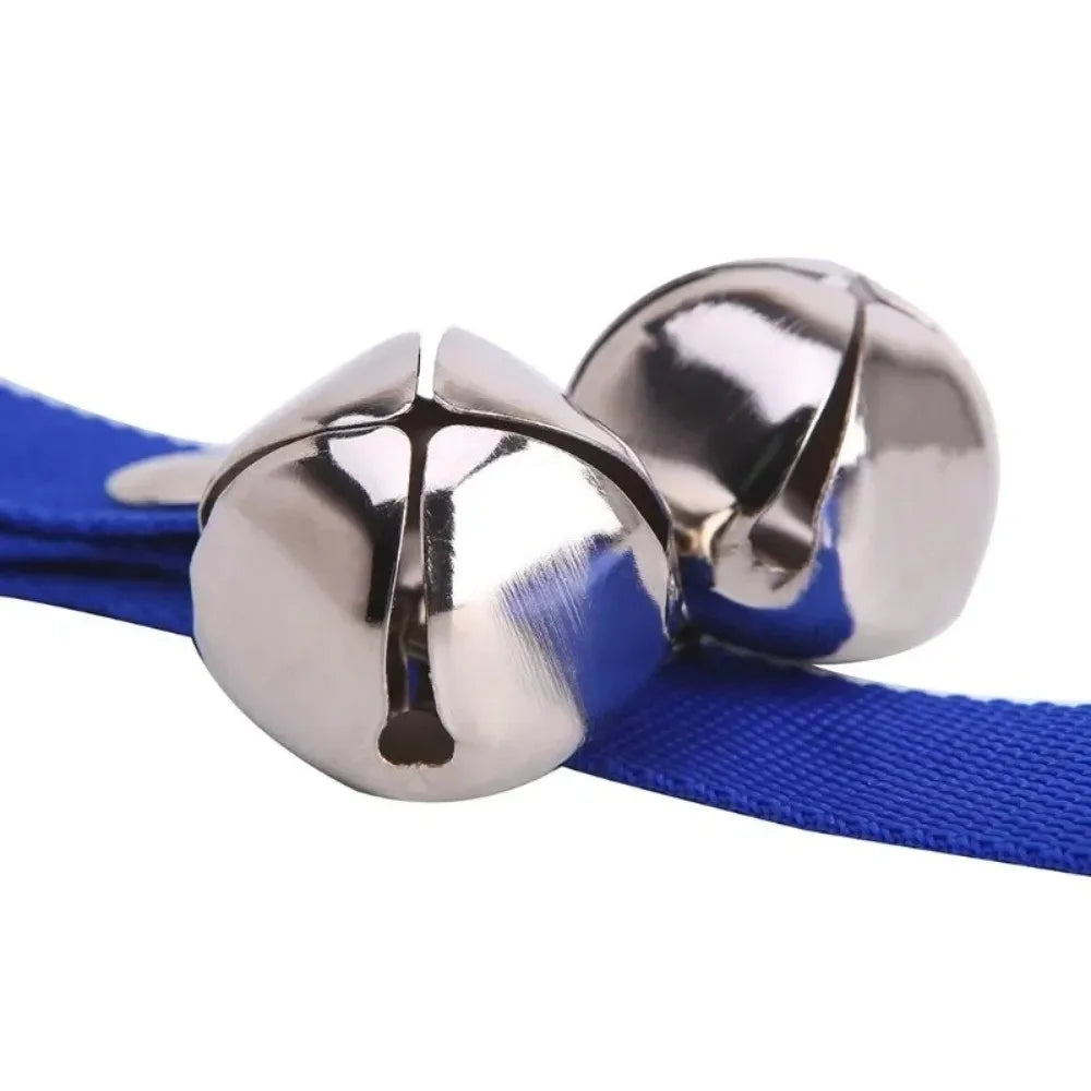 A silver metal adjustable dog doorbell with a blue strap is shown.