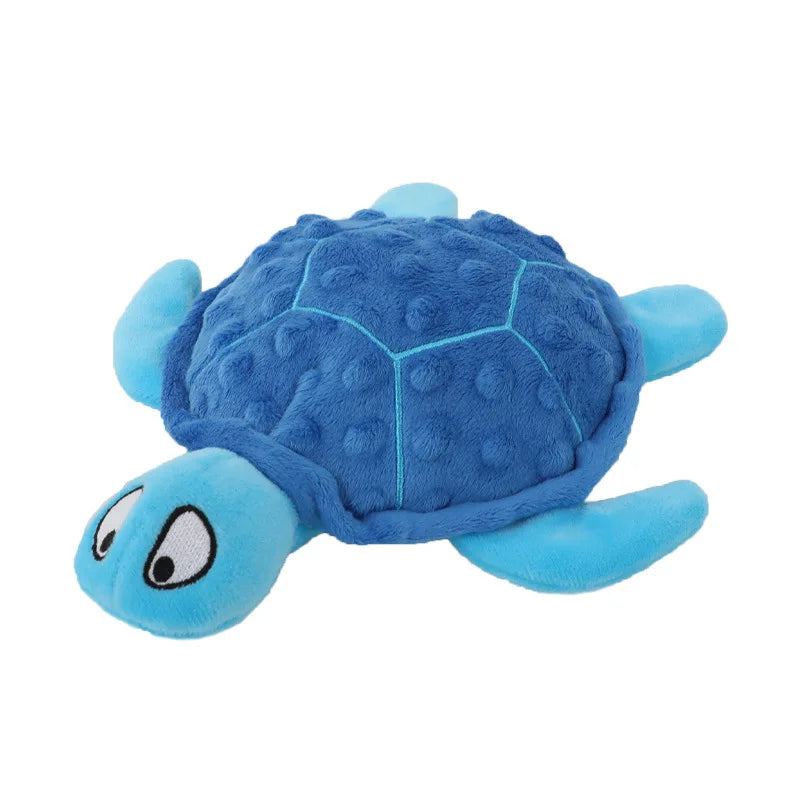 A blue plush toy shaped like a turtle with a smiling face.