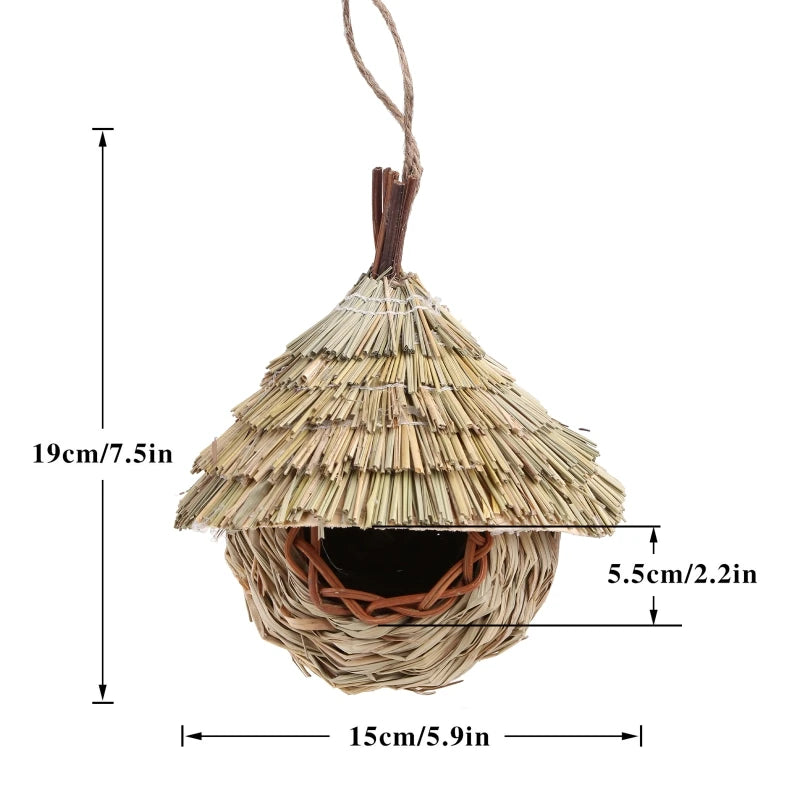 A natural grass hanging bird nest with a conical roof and a woven entrance.