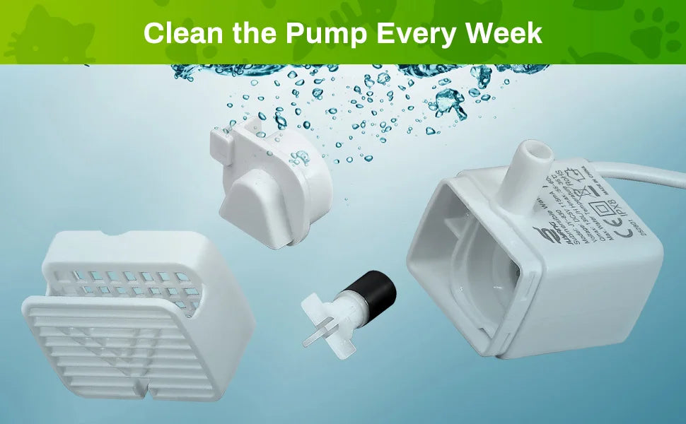 White replacement pump and cleaning brush for a cat water fountain, shown with water droplets.