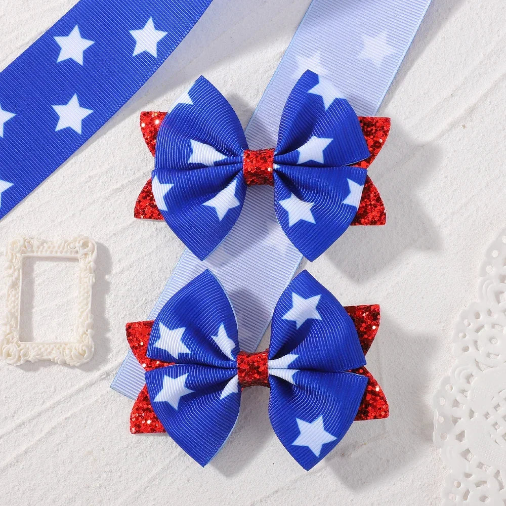 A pair of blue and white patriotic ribbon hair bows with red glitter accents and clips.
