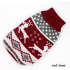 A knitted winter dog sweater in red and white patterns for a small breed dog.