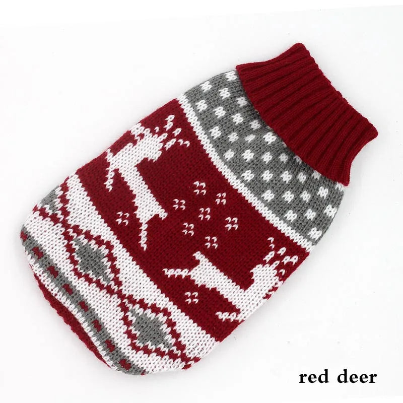 A knitted winter dog sweater in red and white patterns for a small breed dog.