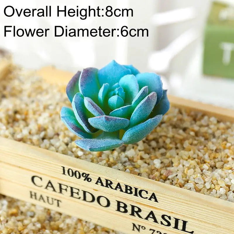 Blue artificial succulent plant with an 8cm height and 6cm diameter placed on a wooden surface.