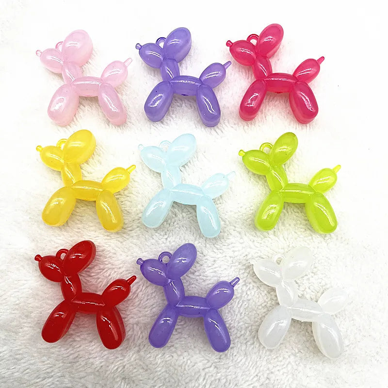 A collection of eight colorful acrylic balloon dog charms in pink, purple, red, yellow, blue, green, and white.