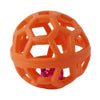 An orange natural rubber dog chew ball with a bell, featuring an open honeycomb structure.
