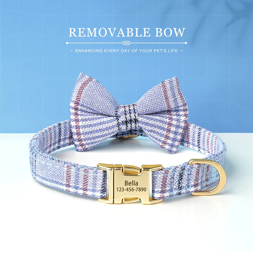 A blue and purple plaid bowtie dog collar with a gold buckle and engraved nameplate.
