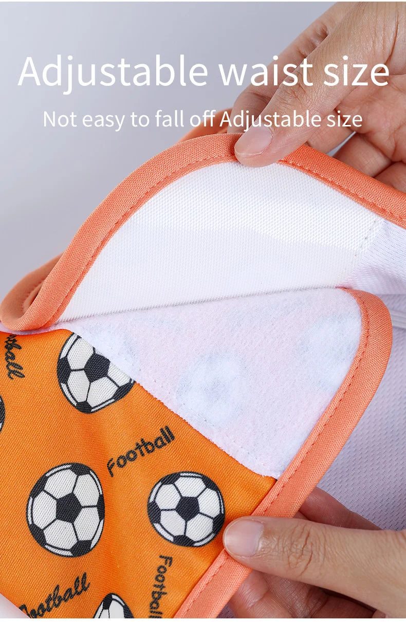 Orange and white reusable male dog sanitary pants with an adjustable waist size shown being held by a hand.