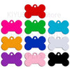 A collection of bone-shaped dog ID tags in various bright colors including red, green, blue, pink, orange, purple, and black.