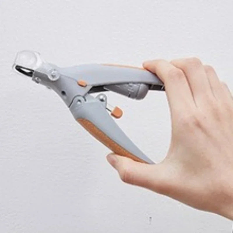 A hand holds a gray and wooden stainless steel pet nail clipper with an LED light.