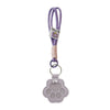 A purple refillable pet hair keychain featuring a cat paw charm.