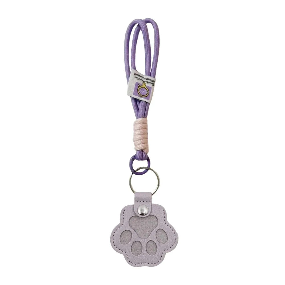 A purple refillable pet hair keychain featuring a cat paw charm.