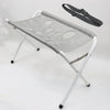 A gray foldable pet grooming hammock station with a black strap is shown against a white background.