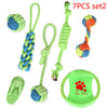 A set of seven green and blue cotton rope dog toys including a chew toy and a green silicone pet mat.