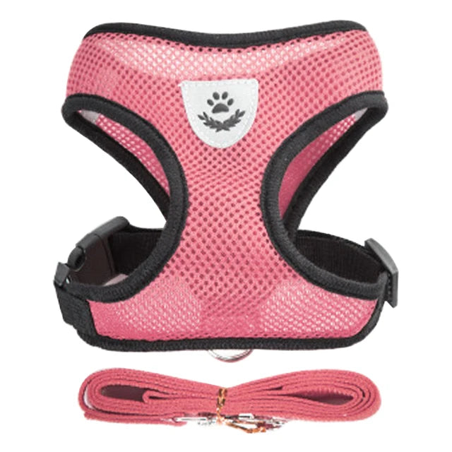 Pink pet harness and leash set with a paw print design