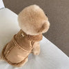 A tan luxury cotton dog vest with a fluffy brown collar and trim, shown on a white surface.