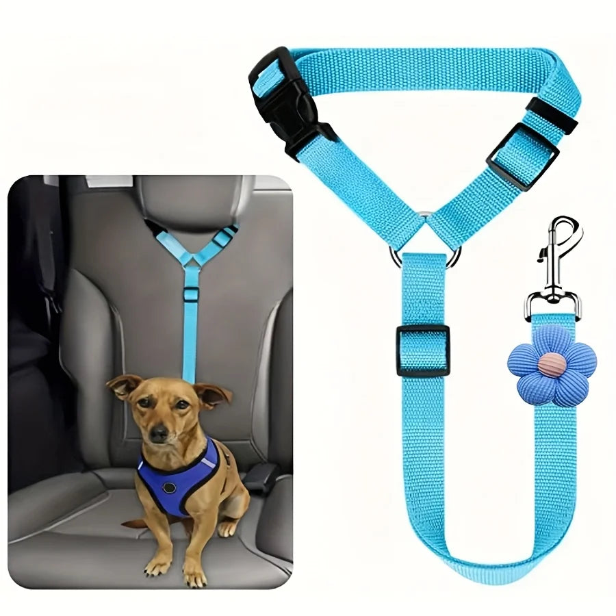 Blue pet car seat belt harness with a clip and a flower-shaped tag for vehicle safety