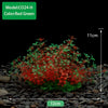 Un amas dense de plantes aquatiques artificielles rouges et vertes sur un substrat de gravier foncé.