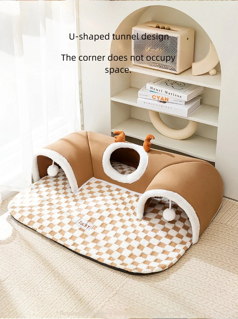 A brown plush cat bed with a reindeer tunnel design and an open storage shelf in a light wood frame.