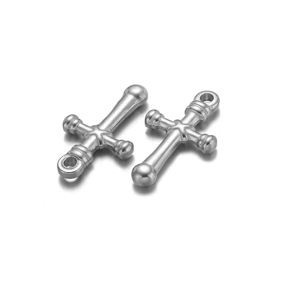 A pair of vintage silver cross charms used for DIY jewelry making.